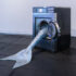 Olivia Erlanger, <em>Pergusa (Gris) </em>, 2022, silicone and paint, commercial washing machine, courtesy of the artist and DM Office, New York. Installation view of <em>Megan Dunn: The Mermaid Chronicles </em> at Te Pātaka Toi Adam Art Gallery. Photo: Ted Whitaker 